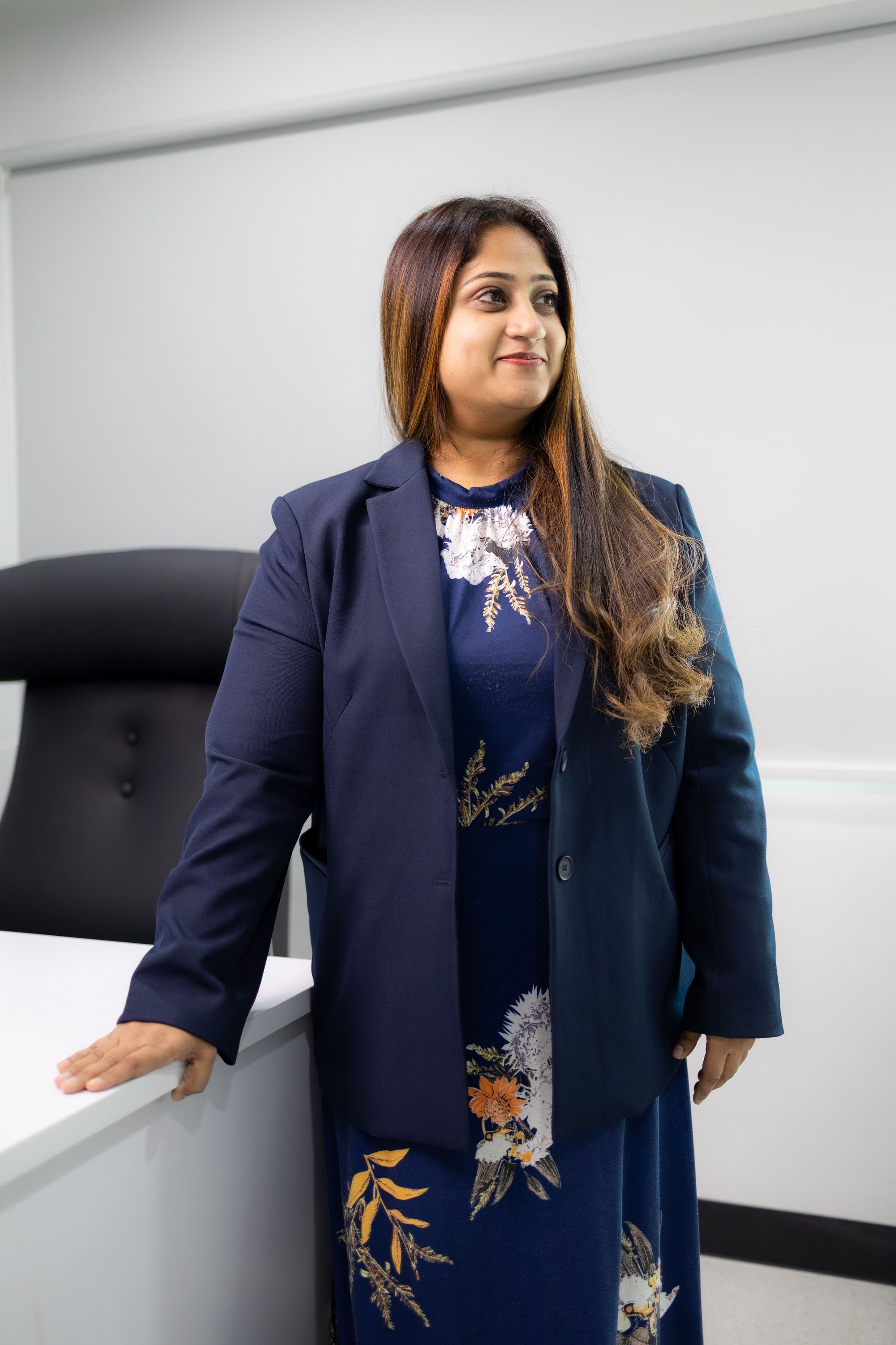 Dr Bheena Vyjhallaja standing beside the desk in her consulting room
