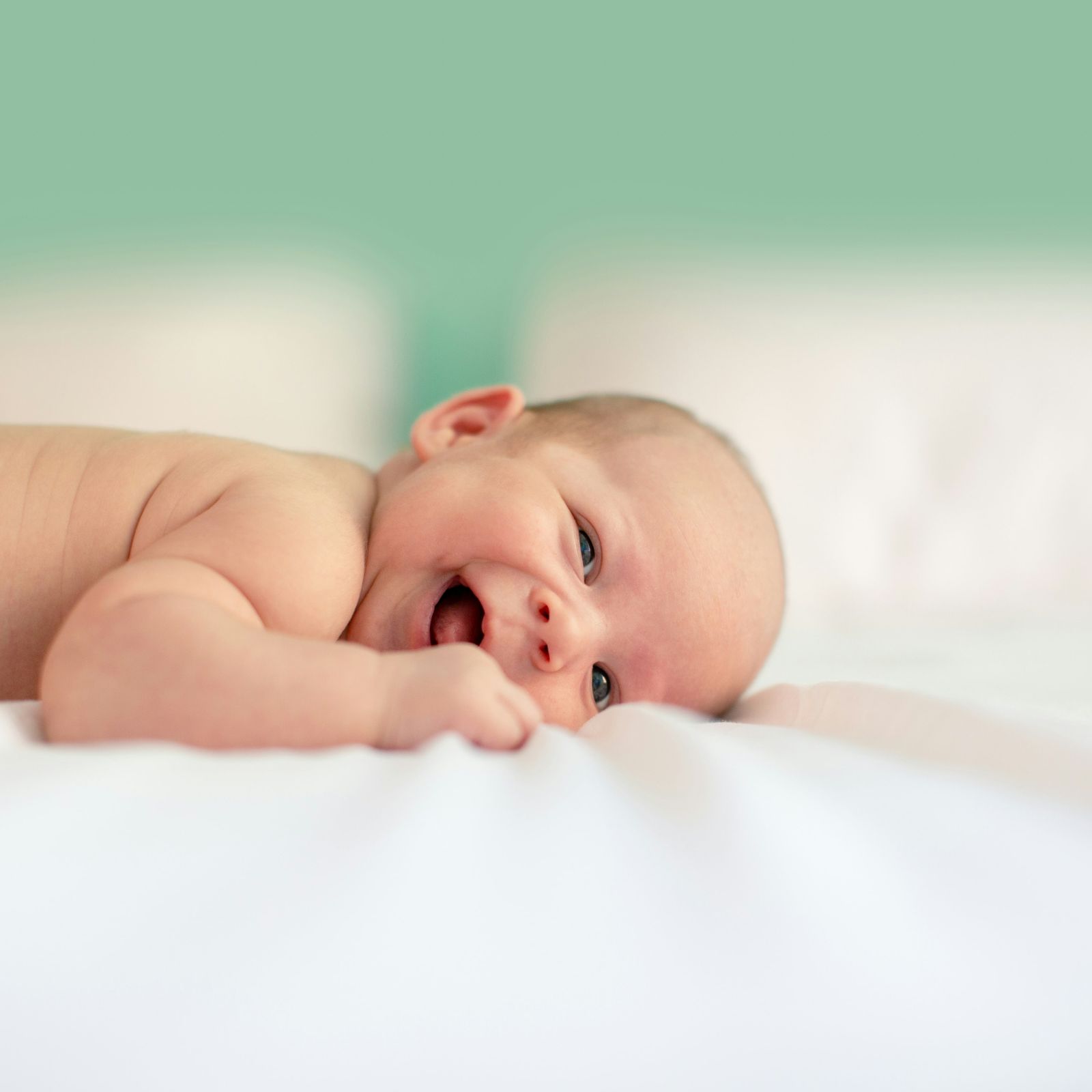 A newborn baby looking towards the camera.